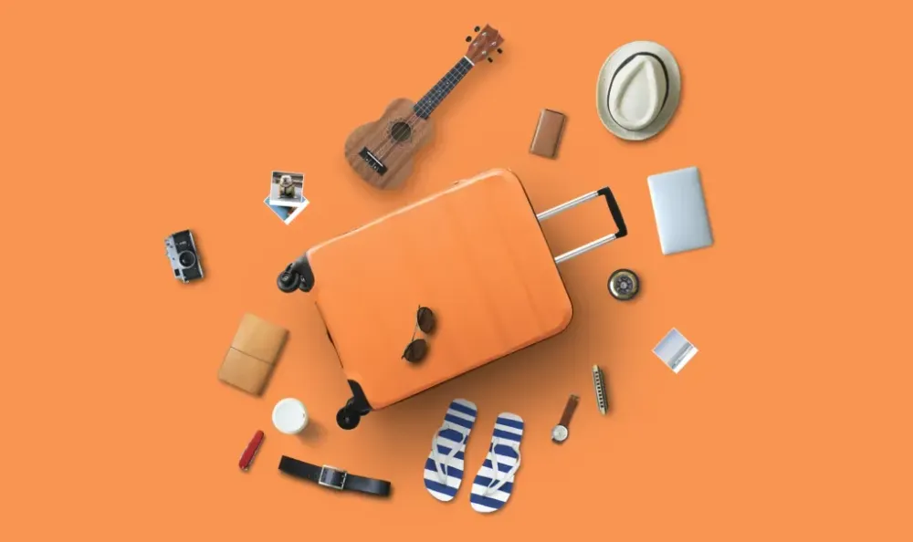 Travel Accessories on Orange Background